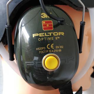 Peltor earmuff installed on the helmet with Push-To-Talk button.