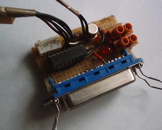 Perfboard with a DIP integrated circuit and a Centronics connector soldered to its edge.